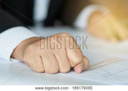 business people hand banging fist with angry on table problems stress workplace desk at office