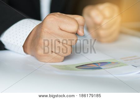 business people hand banging fist with angry on table problems stress workplace desk at office