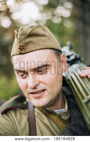 Dyatlovichi, Belarus - October 1, 2016: Man Reenactor Dressed As Russian Soviet Red Army Infantry Soldier Of World War II Marching In Forest With Weapon Machine-gun At Historical Reenactment