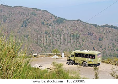 POMPEII, ITALY - October 9 2014: Bus of the Busvia del Vesuvio tours parked at the base of the trail for hiking to the top of the cinder cone of the volcano Mount Vesuvius, south of Naples, Italy.