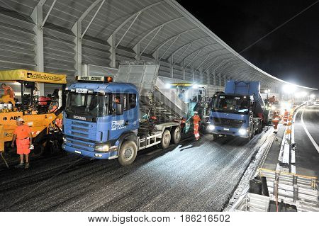 Workers And Vehicles During The Asphalting Of The Highway