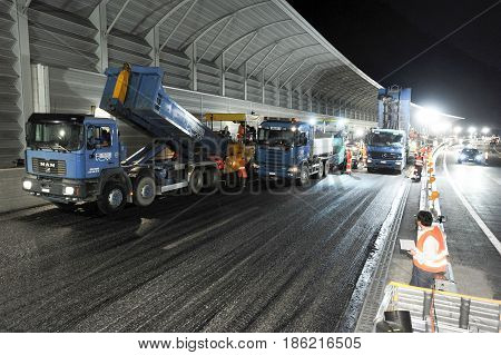 Workers And Vehicles During The Asphalting Of The Highway