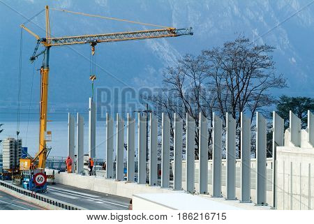 Workers During The Installation Of Noise Barriers On The Highway