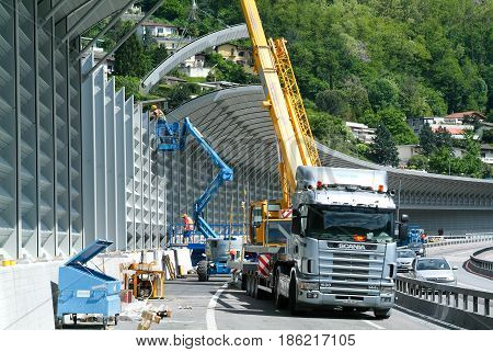 Workers During The Installation Of Noise Barriers On The Highway