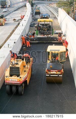 Workers And Vehicles During The Asphalting Of The Highway