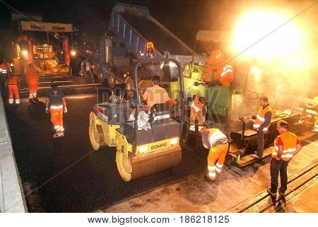 Workers And Vehicles During The Asphalting Of The Highway