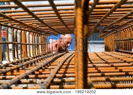 Worker Tying Rebar For Construction