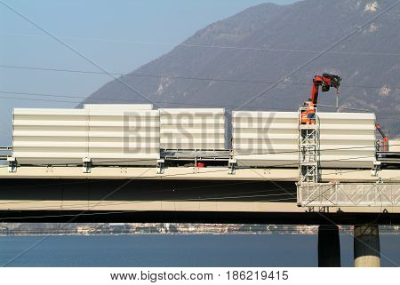 Workers During The Installation Of Noise Barriers On The Highway