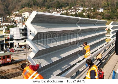 Workers During The Installation Of Noise Barriers On The Highway