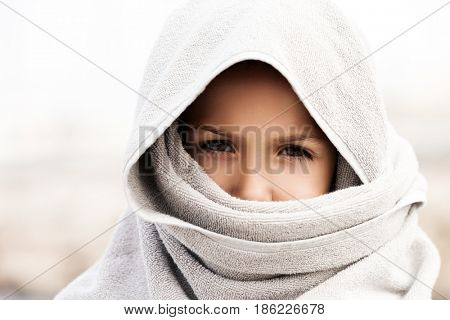 Little child boy wearing arabian nikab or hijab muslim religion style clothing