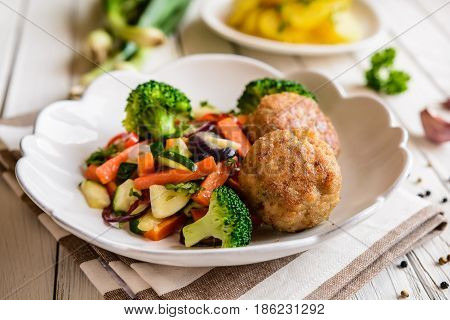 Fried Pork Burgers Served With Steamed Vegetable