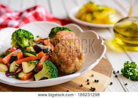 Fried Pork Burgers Served With Steamed Vegetable