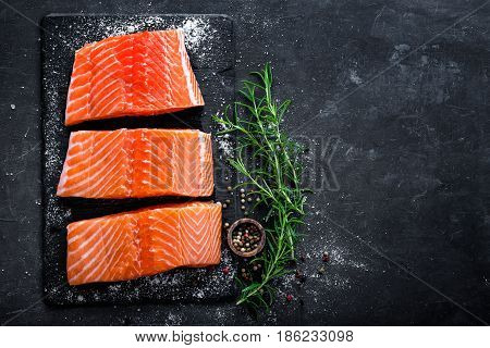 Raw salmon filet on dark slate background wild atlantic fish