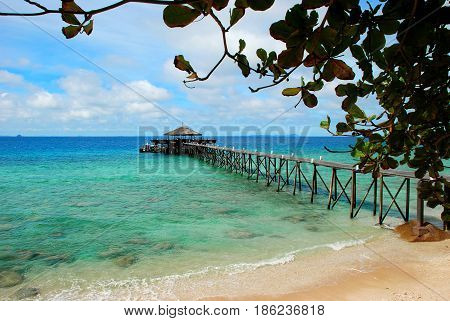 Jetty over clear turquoise waters of Tioman Island Malaysia