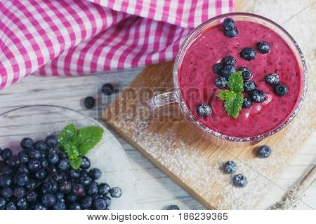 Delicious bilberry smoothie with fresh berries. Fresh yogurt with bilberry. Healthy breakfast.