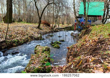 Metallic Wheel Watermill In A Park