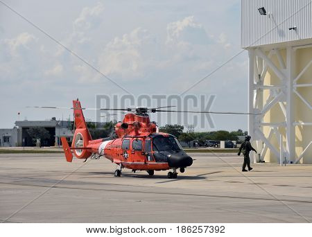 MIAMI - May 12 2017: US Coast Guard helicopter returns from patrol to its base in Miami Florida on May 12 2017. Opa Locka airport is host to a fleet of USCG helicopters.
