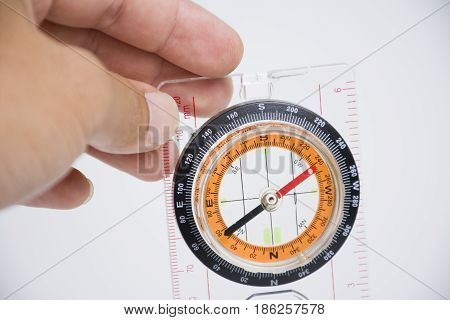 Hand catching Compass isolated on white background