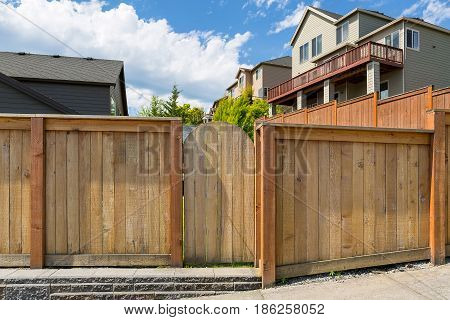 House backyard new wood fence garden gate door in suburban residential neighborhood