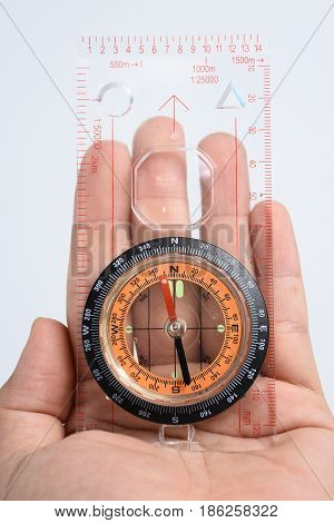 The compass in my hand on white background