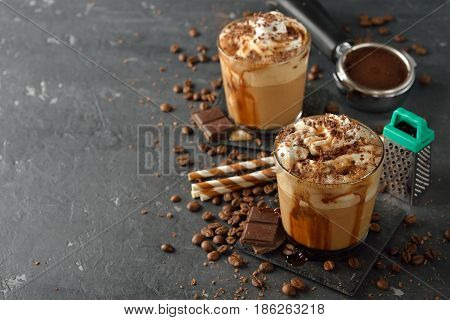 Cold frappe coffee with cream on a gray background