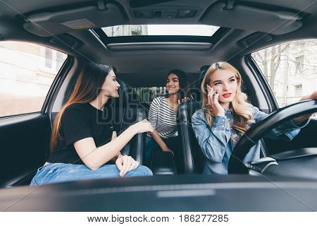 Two Beautiful Young Women Friends Talking Together In The O Car As They Go On A Road Trip White Driv