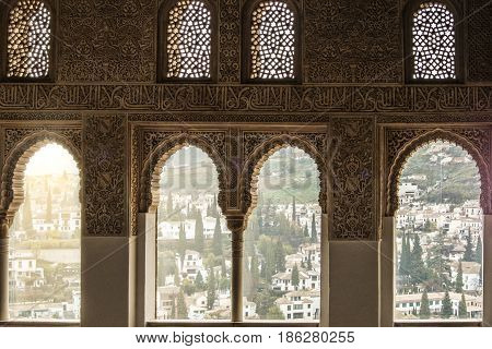 Granada, Spain - February 10, 2015: A View To Old White Houses Of Granada Through A Window Decorated