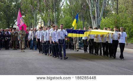 MARGANETS UKRAINE - MAY 9 2017: Veterans representatives of local authority and different town organisations townspeople and school seniors participate in the parade dedicated to celebrating 72th anniversary of Victory over Nazism in the Second World War