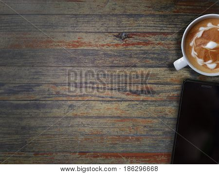 Black Cell phone and art cappuccino. top view with copy space
