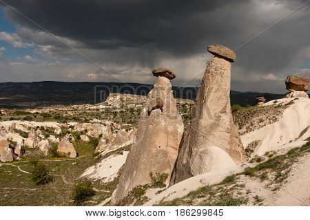 Vertical Shot Of Two Fairy Chimneys Of Cappadocia Shot On Cloudy Day