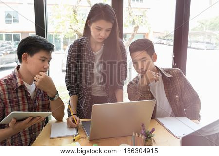 Young University Students Studying With Computer And Tablet In Cafe. Group Of People In Campus Libra