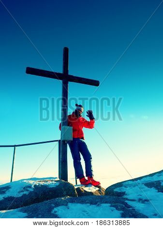 Tourist In Winter Clothes On Summit  With Crucifix