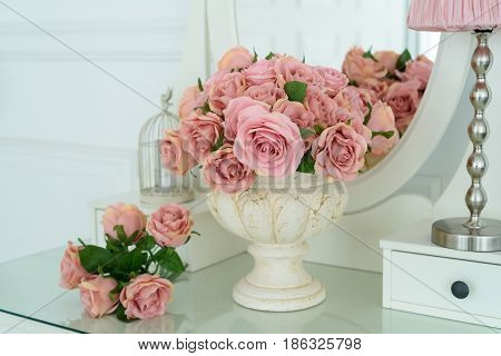 Bouquet Of Pink Rores In Vase On White Boudoir Table With Oval Mirror. Detail Of The Interior Of The