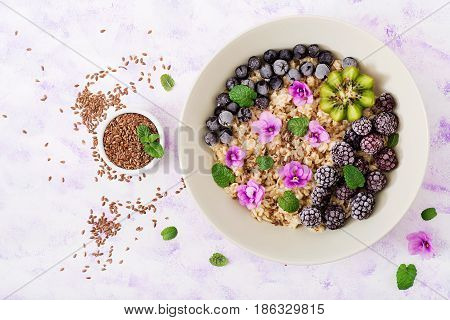 Tasty And Healthy Oatmeal Porridge With Fruit, Berry And Flax Seeds. Healthy Breakfast. Fitness Food