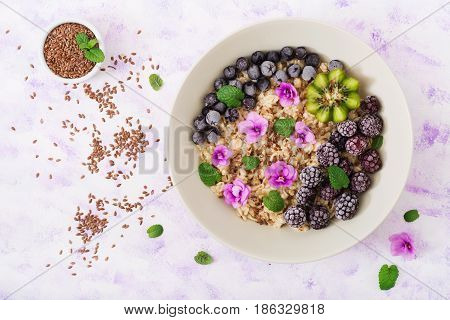Tasty And Healthy Oatmeal Porridge With Fruit, Berry And Flax Seeds. Healthy Breakfast. Fitness Food