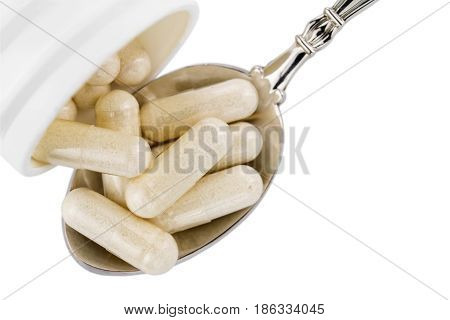 Capsules of glucosamine chondroitin healthy supplement pills in the spoon and white container isolated on white background top view.