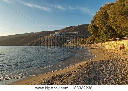 Amorgos Island Greece - October 2015: Beautiful young and barefoot woman with short blond hair watching the golden sunset on a Greek Island Amorgos