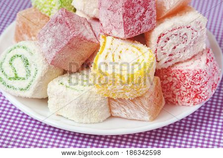 Set of assorted traditional eastern desserts. Arabian sweets on a metal dish. rahat lokum in a colorful plates. Selective focus