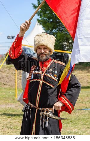 BERLIN - JUNE 11 2016: Russian Cossack with the Russian flag. German-Russian festival devoted to the Independence Day of Russia. District Karlshorst East Berlin.
