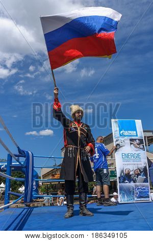 BERLIN - JUNE 11 2016: Russian Cossack with the Russian flag. German-Russian festival devoted to the Independence Day of Russia. District Karlshorst East Berlin.