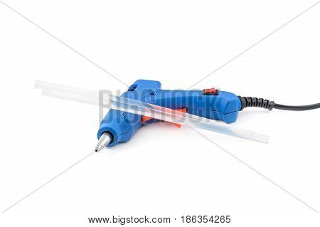 Glue gun with glue rods on a white background.