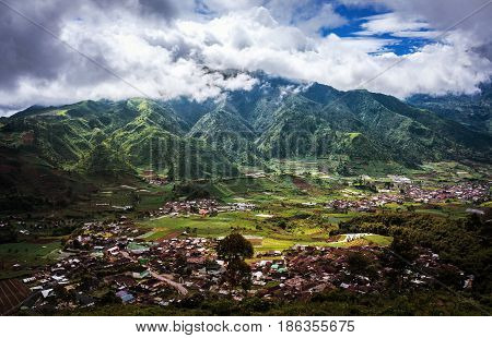 Beautiful view of house and mountain village with rice terrace. Java island, Indonesia.