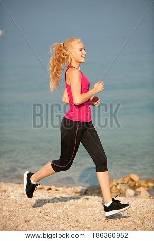 Jogging In Th Beach - Woman Runns Near Sea On Early Summer Morning