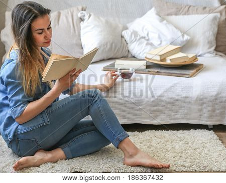 Girl Reading A Book In A Cozy Room