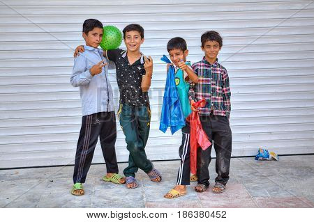 Bandar Abbas Hormozgan Province Iran - 16 april 2017: Four boys of teenage friends twisted and gesticulated at the sight of a tourist with a camera.