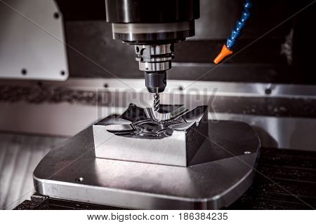 Metalworking CNC milling machine. Cutting metal modern processing technology. Small depth of field. Warning - authentic shooting in challenging conditions. A little bit grain and maybe blurred.