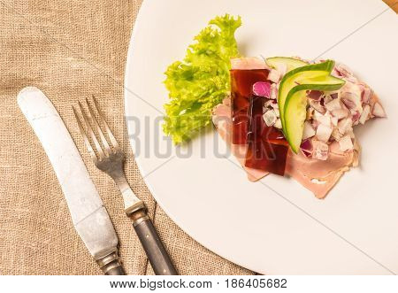 Danish specialties and national dishes high-quality open sandwich. Sandwich with pork roll sausage rullepoelse jelly and raw red onions served on a plate ready for eating