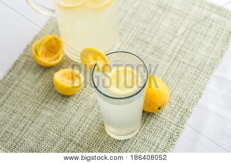 Lemonade juice with lemon slices. Lemonade is traditionally a homemade drink made with squeezed lemon water and sugar a simple recipe for a quick refreshing summer drink packed with vitamin c.