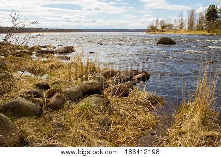 Russia. Leningrad region. Losevo. On the Vuoksa river a rocky shore with rapids and a bridge