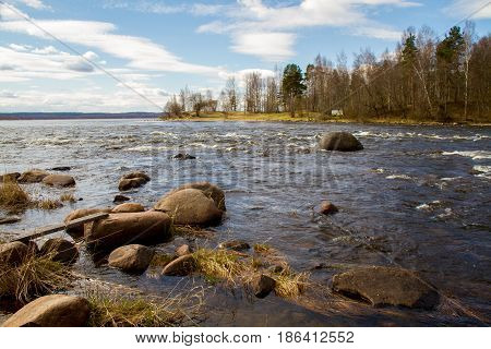 Russia. Leningrad region. Losevo. On the Vuoksa river a rocky shore with rapids and a bridge